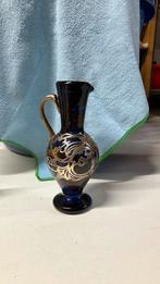 Met zilver afgewerkt vaasje, Ophalen