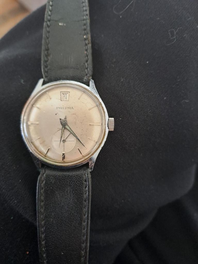 Prisma herenhorloge met datum, Ophalen