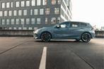 BMW 1 Serie M135i xDrive High Executive Automaat / Panoramad, Auto's, 1998 cc, 1525 kg, Zwart, Stoelverwarming