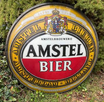groot rond reclame bord van Amstel Bier uit een lichtbak. beschikbaar voor biedingen