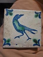 Antiek wandtegel met vogel, Ophalen