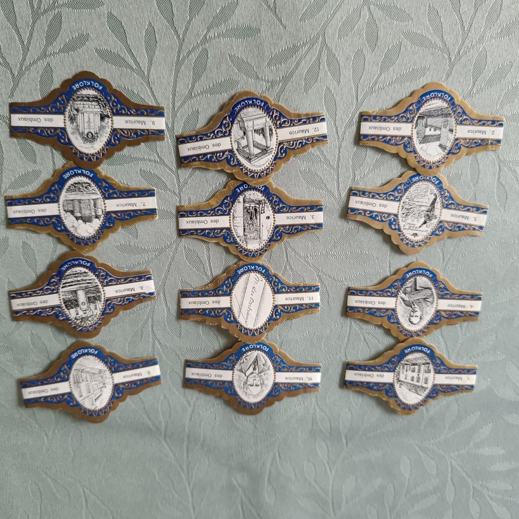 12 sigarenbandjes Folklore Maurice des Ombiaux, Ophalen of Verzenden, Gebruikt, Reclamebord