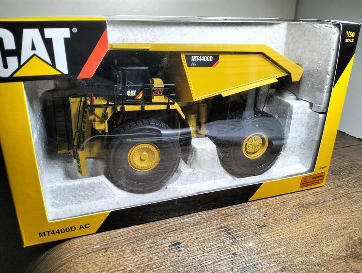 Te koop Tonkin Replicas CAT MT4400D AC Truck., Hobby en Vrije tijd, Modelauto's | 1:50, Zo goed als nieuw, Bus of Vrachtwagen