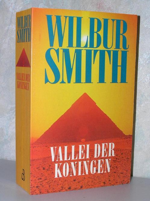 Wilbur Smith - Vallei der koningen (oranje paperback), Boeken, Romans, Zo goed als nieuw, Nederland, Ophalen of Verzenden