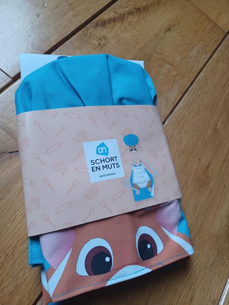 AH Hamster - schort en muts - nieuw, Huis en Inrichting, Keuken | Textiel, Ophalen of Verzenden, Nieuw, Blauw, Schort
