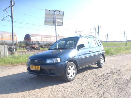 Mazda Demio 1.3 Comfort 1999 Blauw Trekhaak NIEUWE APK, Auto's, Mazda, Bedrijf, Demio, Airbags, Dakrails, Metallic lak, Open dak
