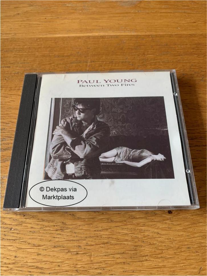 Cd Paul Young - Between Two Fires, Cd's en Dvd's, Cd's | Rock, Gebruikt, Poprock, Ophalen of Verzenden