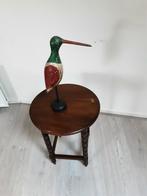 Houten vogel, Ophalen