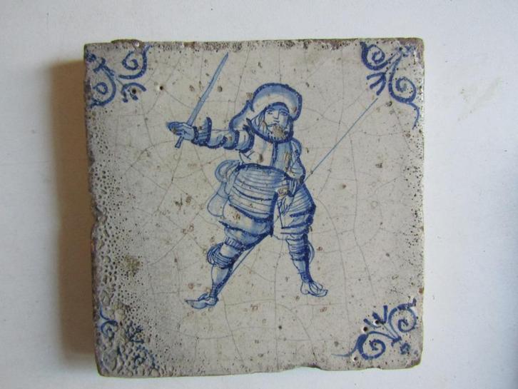 een 17e eeuwse tegel met een soldaatmet zwaard en spies., Antiek en Kunst, Antiek | Wandborden en Tegels, Ophalen of Verzenden