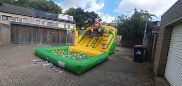 Springkussen, glijbaan 'splashy Jungle slide' te huur beschikbaar voor biedingen