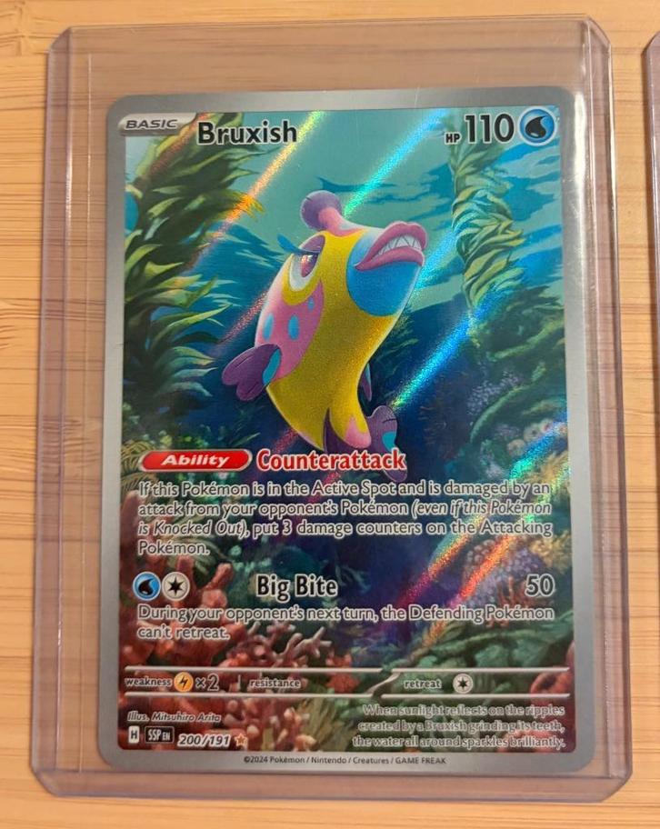 Bruxish 200/191 | Surging Sparks illustration rare Pokémon, Hobby en Vrije tijd, Verzamelkaartspellen | Pokémon, Zo goed als nieuw