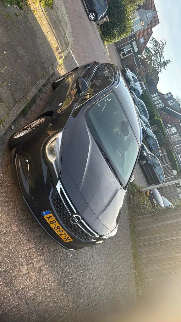 Opel Astra 1.0 Turbo 77KW Sports Tourer AUT 2016 Zwart, Auto's, USB, 1178 kg, 620 kg, Origineel Nederlands