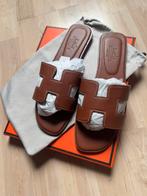 Oran slippers bruin 39 valt als 38, Kleding | Dames, Schoenen, Slippers, Bruin, Nieuw, Ophalen of Verzenden