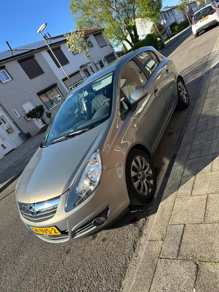 Opel Corsa 1.2 Twinport 85pk 5d 2010 Bruin, Auto's, Voorwielaandrijving, Stof, 4 cilinders, Bruin