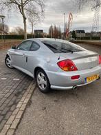 Hyundai Coupé 2.0 bouwjaar 2003 Grijs metalic, Auto's, Voorwielaandrijving, Stof, Zwart, Particulier