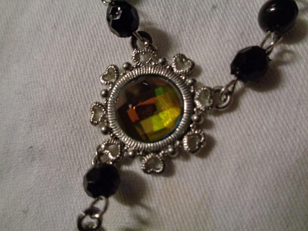 zilverkleurige ketting  met tand en tussen stuk nr k 5737, Sieraden, Tassen en Uiterlijk, Kettingen, Nieuw, Ophalen of Verzenden