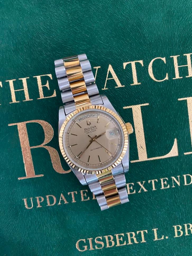 Bulova Super Seville Day Date, Sieraden, Tassen en Uiterlijk, Horloges | Heren, Gebruikt, Overige merken, Staal, Ophalen of Verzenden