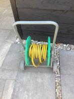 Te koop haspelwagen met slang € 10.=, Tuin en Terras, Tuinslangen, Ophalen of Verzenden, Zo goed als nieuw, Tuinslang
