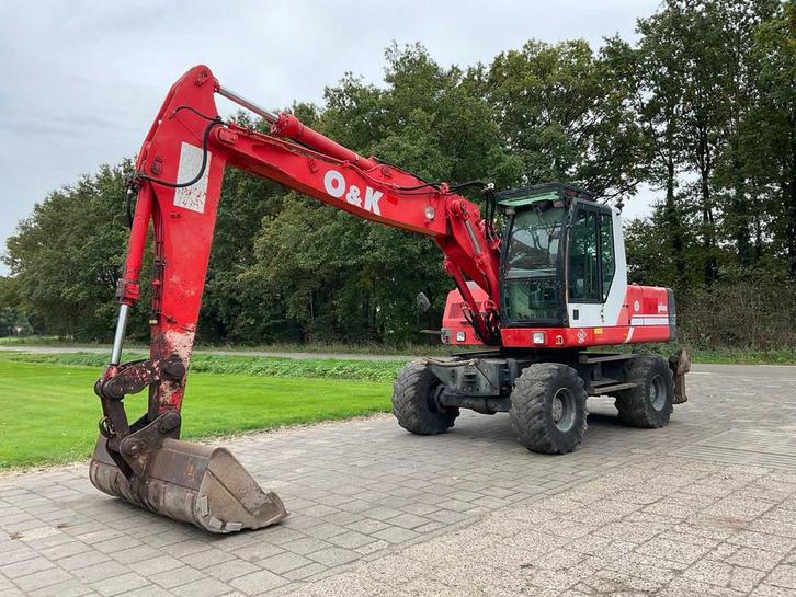 1999 O&K MH Plus Banden graafmachine, Zakelijke goederen, Machines en Bouw | Kranen en Graafmachines, Graafmachine