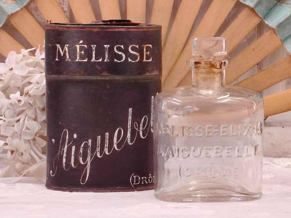 Oud flesje Melissa in blikken foedraal, Antiek en Kunst, Ophalen of Verzenden