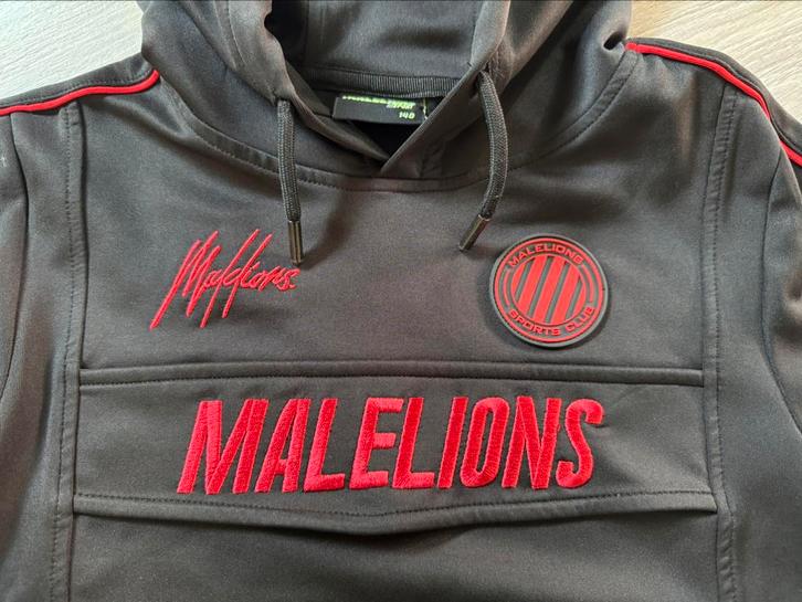 Supergave Malelions trui hoodie, maat 140, zwart-rood, Kinderen en Baby's, Kinderkleding | Maat 140, Gebruikt, Jongen, Trui of Vest