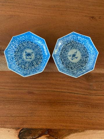 Twee blauw-witte porseleinen schoteltjes beschikbaar voor biedingen