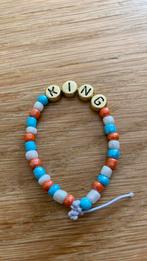 Konings armbandje, Sieraden, Tassen en Uiterlijk, Kindersieraden, Ophalen of Verzenden, Nieuw, Armband