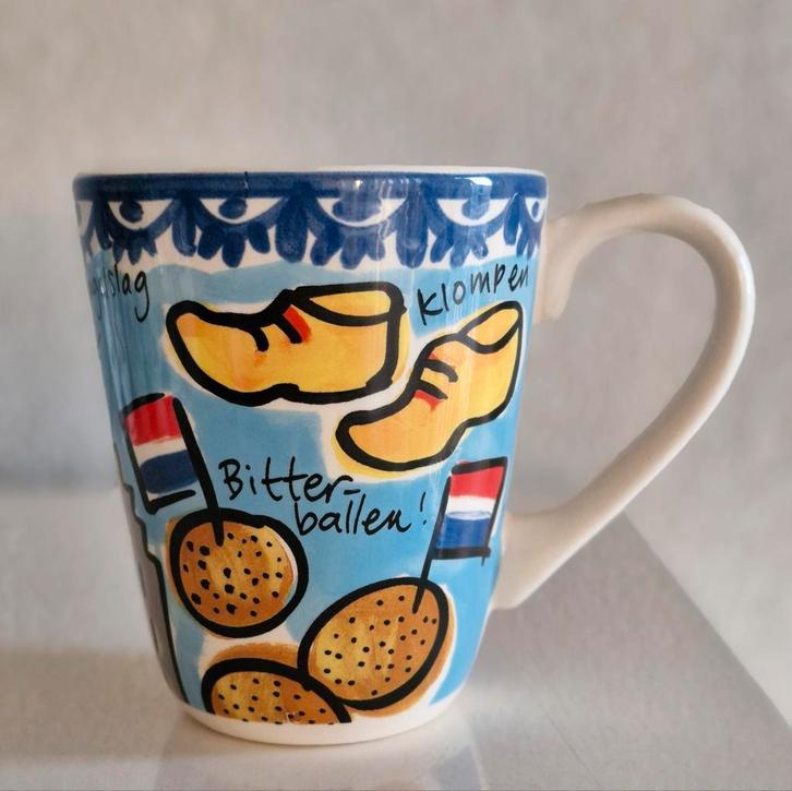 Beker Blond Amsterdam Learing Dutch while you're drinking!, Huis en Inrichting, Keuken | Servies, Zo goed als nieuw, Kop(pen) en/of Schotel(s)