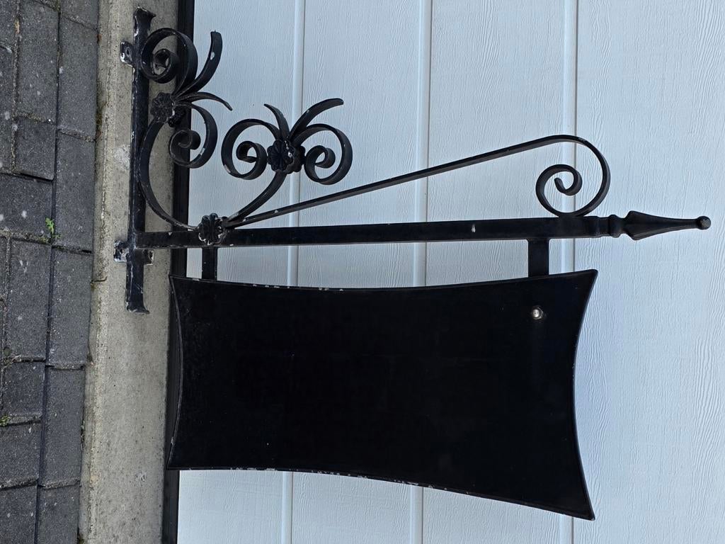 Handgesmede ijzeren uithangbord voor aan een buitenpui, Ophalen