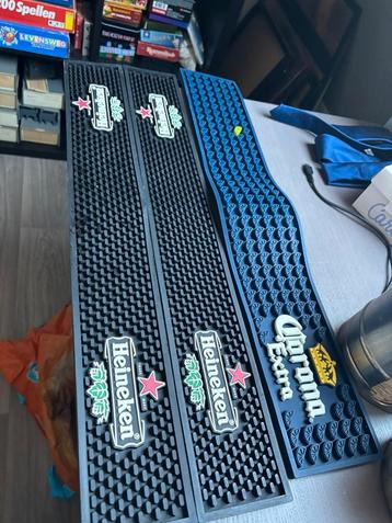 Barmatten Heineken en Corona beschikbaar voor biedingen
