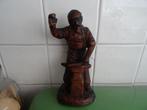 Oud beeld smid met hamer en aambeeld, Ophalen