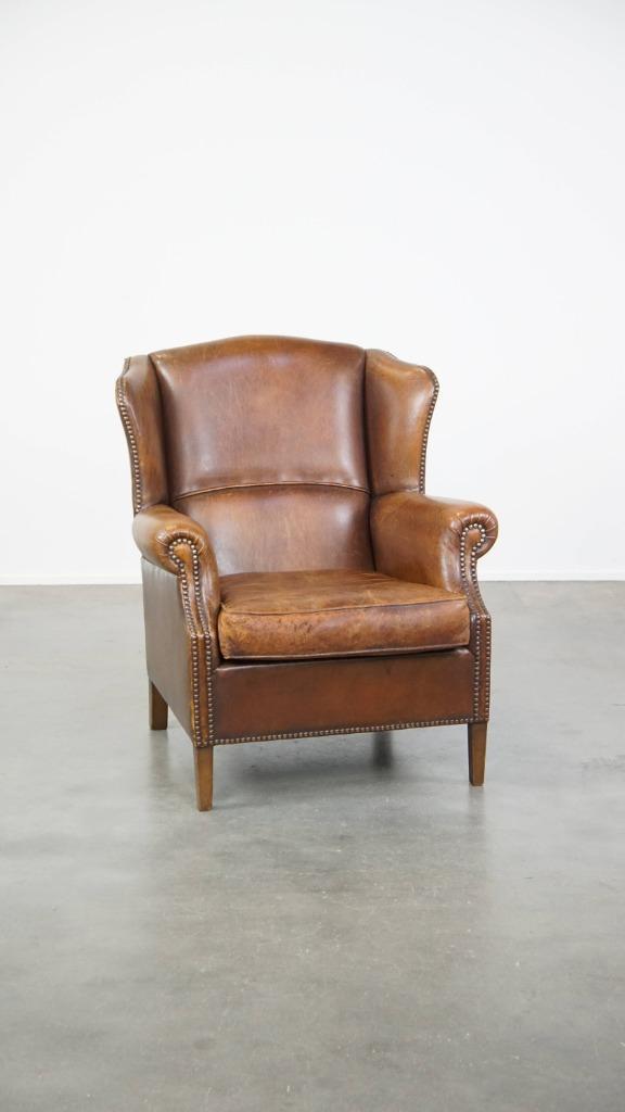 Comfortabele, cognac-kleurige schapenleren oorfauteuil, Huis en Inrichting, Fauteuils, Gebruikt, Leer, 75 tot 100 cm, 75 tot 100 cm