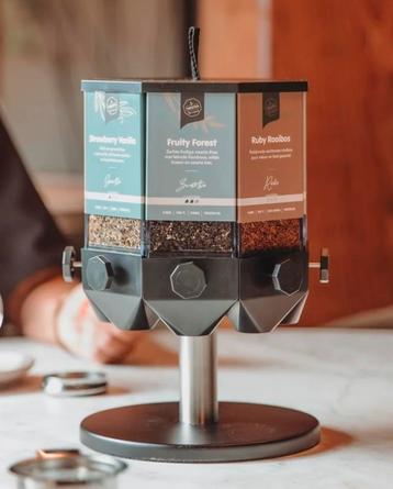 Gezocht: TwisTea display (de vierkante versie met 8 kokers) beschikbaar voor biedingen