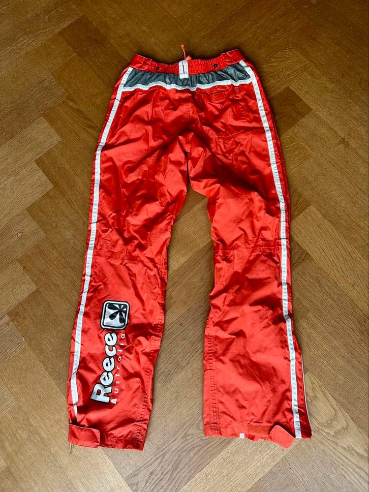 Oranje Reece regenbroek zgan met hoge ritzen maat XS, Sport en Fitness, Hockey, Zo goed als nieuw, Kleding, Ophalen of Verzenden