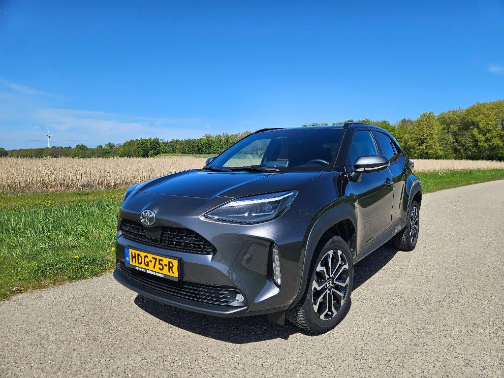 Toyota Yaris Cross 1.5 Vvt-i Hybrid 130pk CVT 2024 Grijs, Auto's, Stof, 1490 cc, 1175 kg, 3 cilinders