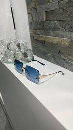 Blauwe zonnebril met goudkleurige frame, Overige merken, Zonnebril, Blauw, Ophalen of Verzenden