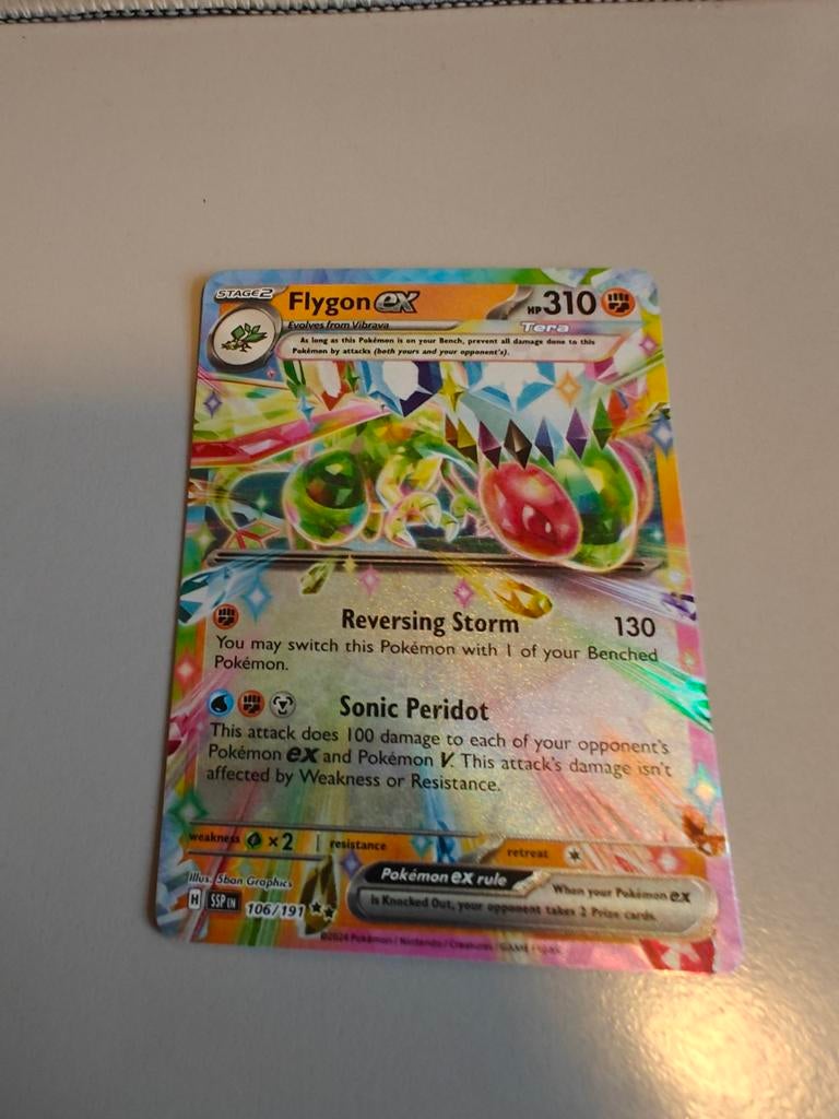 Flygon ex 106/191 Surging Sparks Tera Double Rare NM, Ophalen of Verzenden, Zo goed als nieuw, Losse kaart, Foil