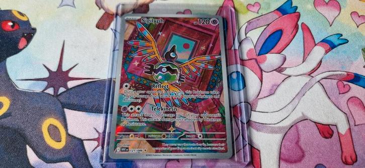 Sigilyph White Flare 121/086, Hobby en Vrije tijd, Verzamelkaartspellen | Pokémon, Zo goed als nieuw, Ophalen of Verzenden