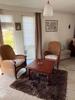 Twee rieten stoelen met houten leuningen en houten poten, Breda