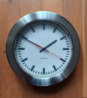 Karlsson roestvrij stalen wandklok beschikbaar voor biedingen
