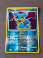 Rising rivals 79/111 shellos reverse, Hobby en Vrije tijd, Verzamelkaartspellen | Pokémon, Foil, Gebruikt, Ophalen of Verzenden