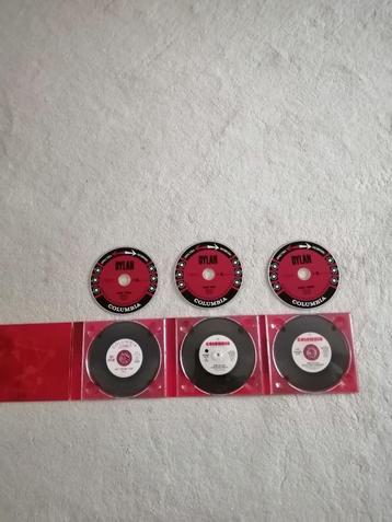 3 Cd box Bob Dylan getiteld DYLAN+ 3 singles +boekwerkje beschikbaar voor biedingen