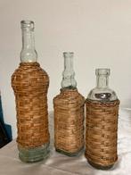 Drie met riet omweven oude flessen grootste is 33x8 cm, Ophalen of Verzenden