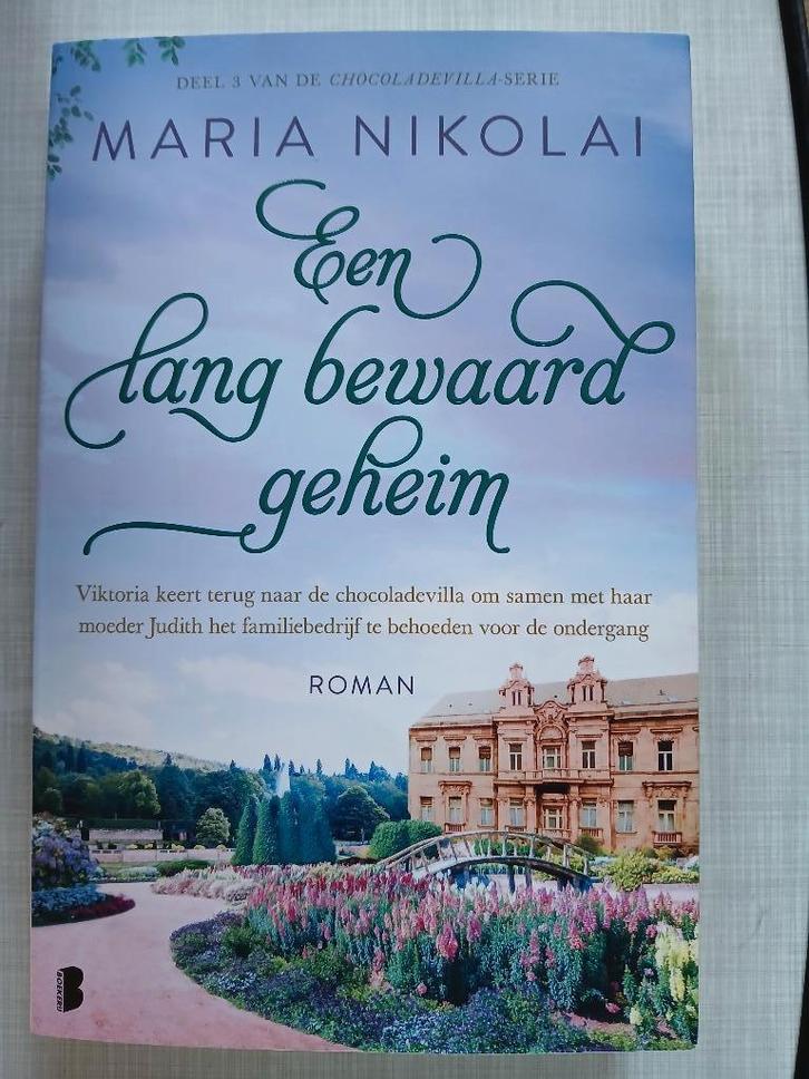 Maria Nikolai - Een lang bewaard geheim, Boeken, Romans, Zo goed als nieuw, Ophalen of Verzenden