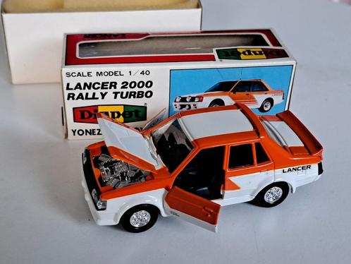 Mitsubishi miniatuur lancer 2000 Rally turbo oranje wit, Hobby en Vrije tijd, Modelauto's | Overige schalen, Zo goed als nieuw