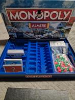 Nieuwe Monopoly Almere - Hoekje doos beschadigd, Hobby en Vrije tijd, Gezelschapsspellen | Bordspellen, Een of twee spelers, Ophalen of Verzenden
