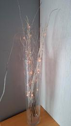 Vaas met verlichting en takken, Ophalen