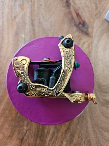 Tatoeage machientje in verguld goud by Laura beschikbaar voor biedingen
