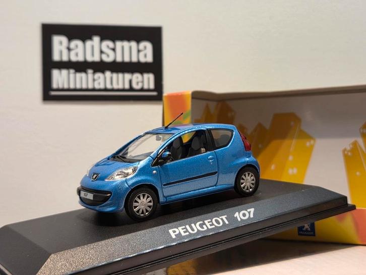 Peugeot 107 - 1e model - Blauw - 1:43 Norev, Hobby en Vrije tijd, Modelauto's | 1:43, Zo goed als nieuw, Auto, Norev, Ophalen of Verzenden