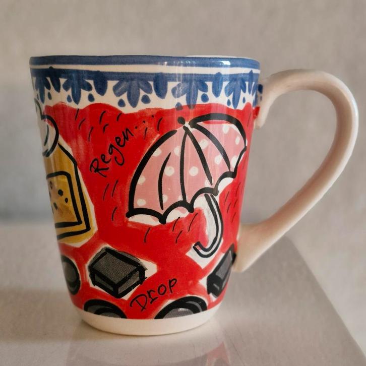 Beker Blond Amsterdsm Learining Dutch while you're drinking!, Huis en Inrichting, Keuken | Servies, Zo goed als nieuw, Kop(pen) en/of Schotel(s)